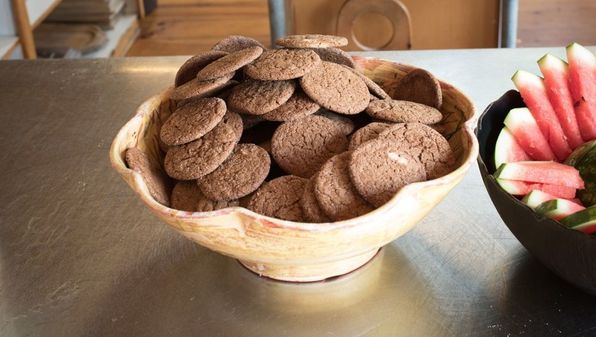 Bowl of fresh gingersnap cookies in a wooden bowl